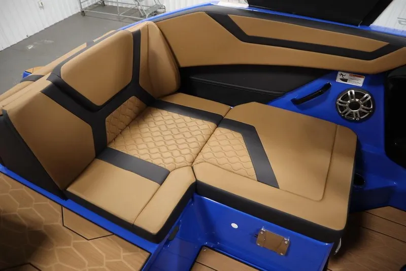 Slide: The Image of 2024 Yamaha Boats 222XE interior with tan and black seating, blue accents, and speaker. - 41
