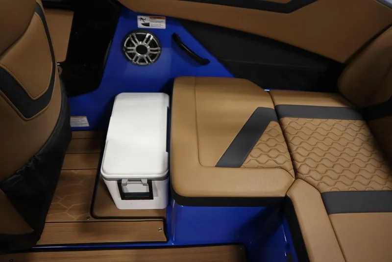 Slide: The Image of 2024 Yamaha Boats 222XE interior with tan seating, blue accents, and integrated speaker. - 45