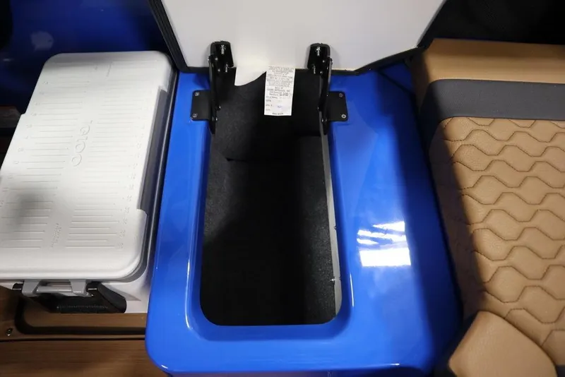 Slide: The Image of 2024 Yamaha Boats 222XE interior storage compartment with cooler and cushioned seating. - 46