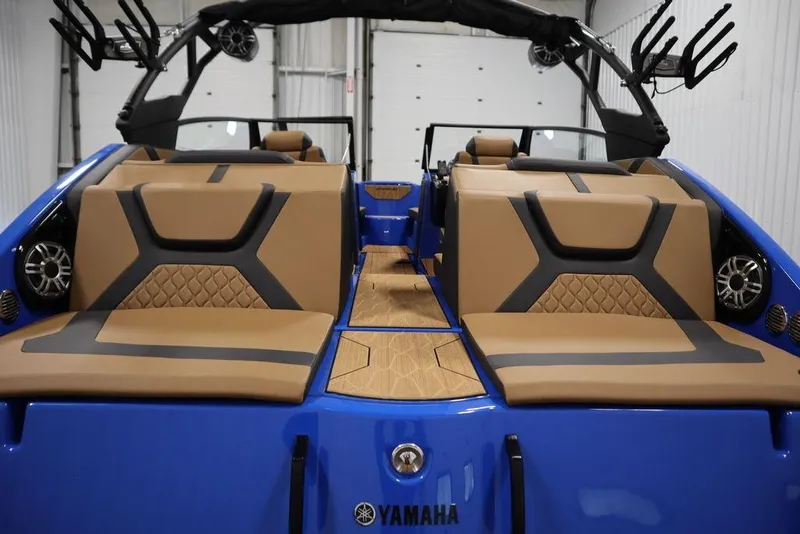 Slide: The Image of 2024 Yamaha Boats 222XE interior with tan and black seating, blue exterior, and modern design. - 50