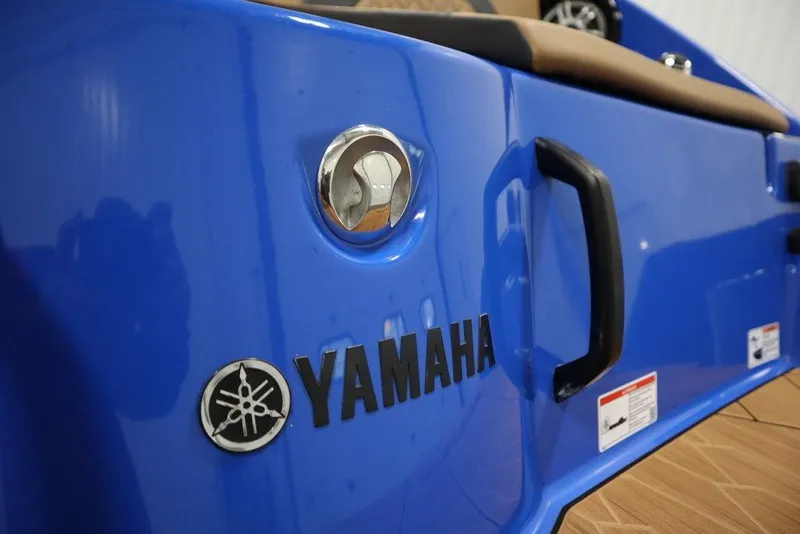 Slide: The Image of 2024 Yamaha Boats 222XE, blue exterior with logo and handle detail. - 53