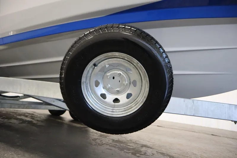 Slide: The Image of Trailer wheel of 2024 Yamaha Boats 222XE, showcasing sturdy design and construction. - 55