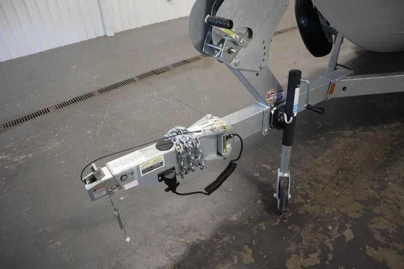 Slide: The Image of Trailer hitch of 2024 Yamaha Boats 222XE, featuring safety chains and jack stand. - 57