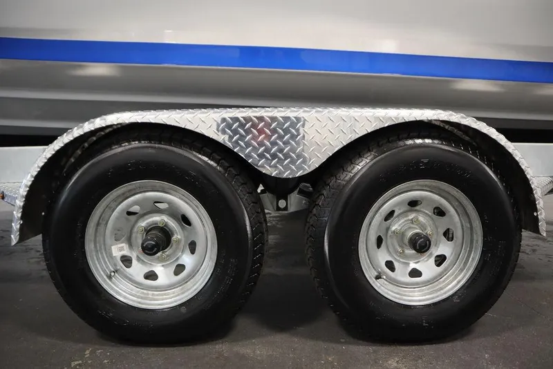 Slide: The Image of Trailer wheels of a 2024 Yamaha Boats 222XE with diamond plate fender. - 58