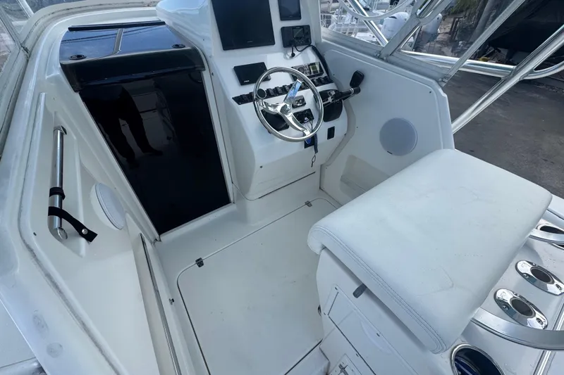 Slide: The Image of 2002 Contender 31 Fisharound boat cockpit with steering wheel and seating area. - 4