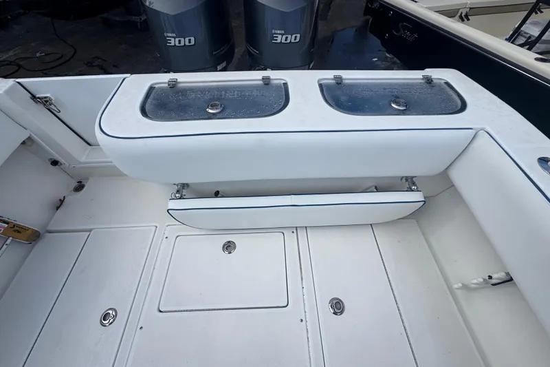 Slide: The Image of 2002 Contender 31 Fisharound boat deck with storage compartments and Yamaha 300 engines. - 6