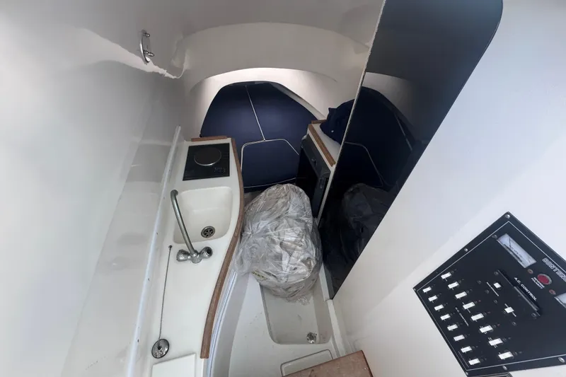 Slide: The Image of 2002 Contender 31 Fisharound cabin interior with sink, stove, and control panel. - 8