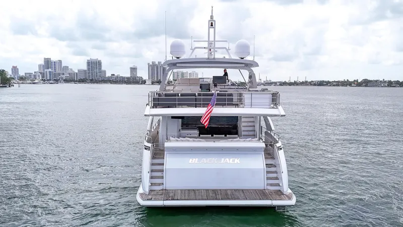 Slide: The Image of 2017 Azimut 95 Raised Pilothouse yacht on water with city skyline background. - 15