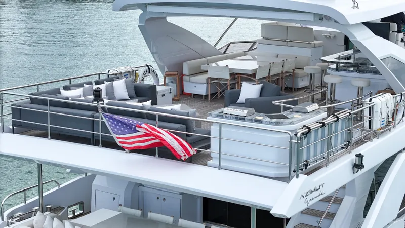 Slide: The Image of Luxurious 2017 Azimut 95 Raised Pilothouse yacht with spacious deck and American flag. - 19