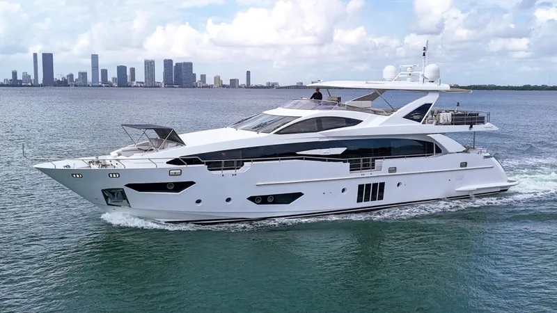 Slide: The Image of Luxury 2017 Azimut 95 Raised Pilothouse yacht cruising near city skyline. - 27