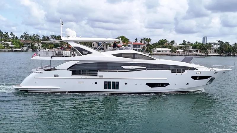 Slide: The Image of Luxury 2017 Azimut 95 Raised Pilothouse yacht cruising on a scenic waterway. - 32