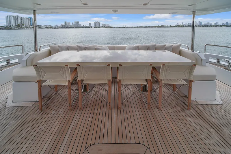 Slide: The Image of Azimut 95 Raised Pilothouse 2017 yacht deck with dining area overlooking water. - 35