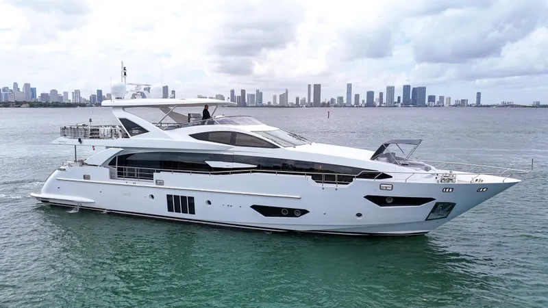 Slide: The Image of Luxurious 2017 Azimut 95 Raised Pilothouse yacht cruising near a city skyline. - 4
