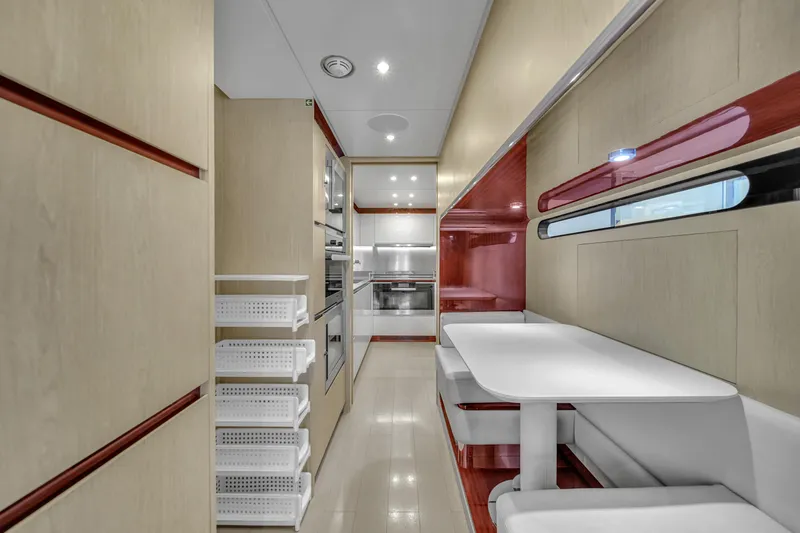 Slide: The Image of Modern kitchen interior of 2017 Azimut 95 Raised Pilothouse yacht, featuring sleek design and appliances. - 47