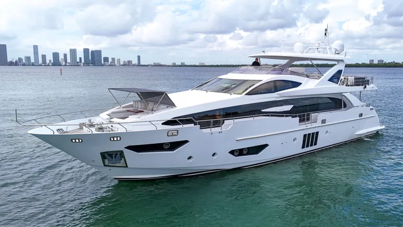 Slide: The Image of Luxury 2017 Azimut 95 Raised Pilothouse yacht cruising near city skyline. - 9