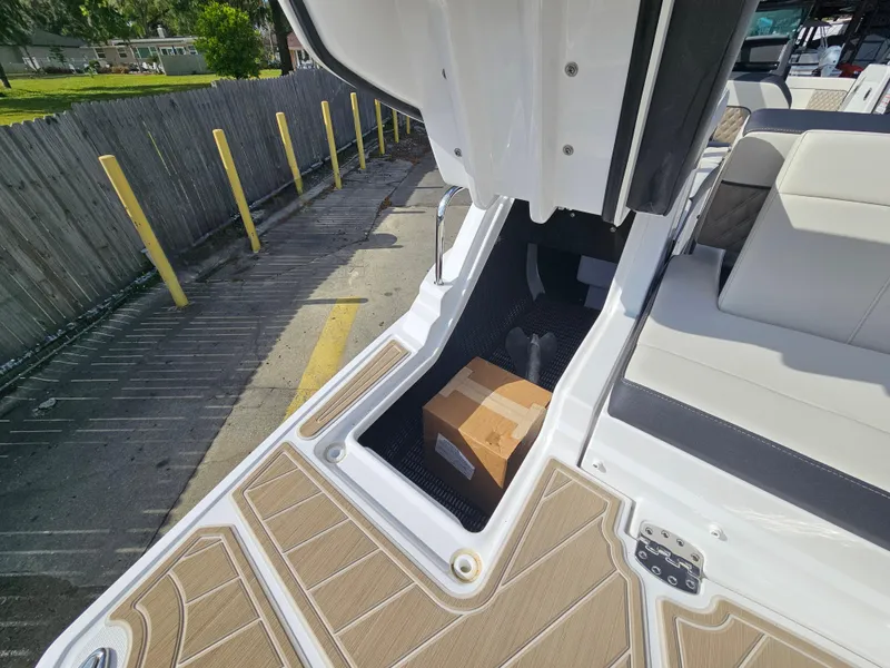 Slide: The Image of 2025 Monterey M-65 boat storage compartment with a package inside, dockside view. - 15