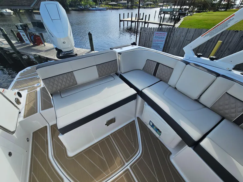 Slide: The Image of 2025 Monterey M-65 boat with luxurious seating, docked by a serene waterfront. - 17