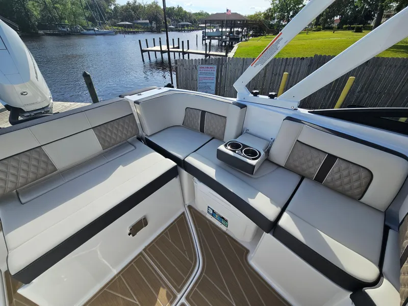 Slide: The Image of Luxurious seating area on a 2025 Monterey M-65 boat, featuring elegant upholstery and cup holders. - 19