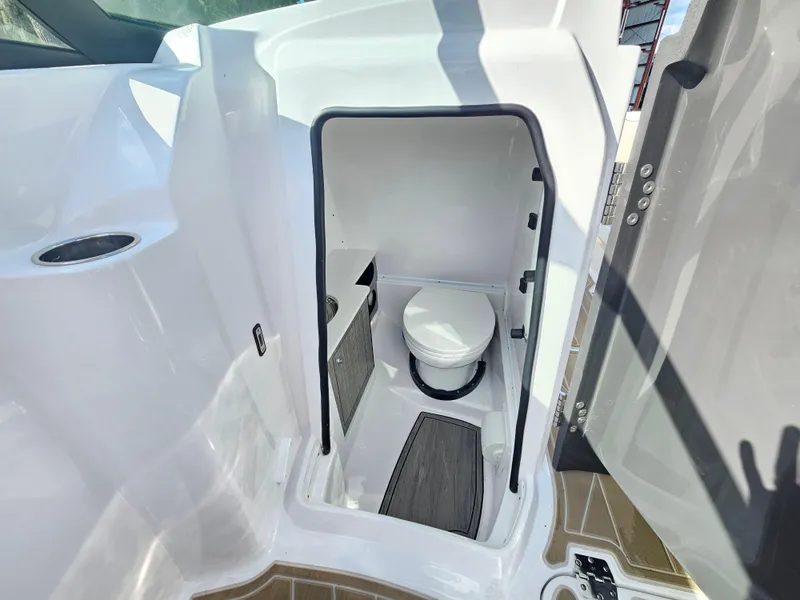 Slide: The Image of Compact bathroom in 2025 Monterey M-65 boat, featuring a modern toilet and sleek design. - 23