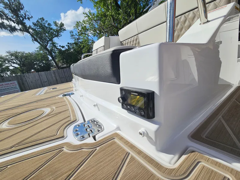 Slide: The Image of 2025 Monterey M-65 boat deck with seating and control panel, featuring sleek design and wood finish. - 25