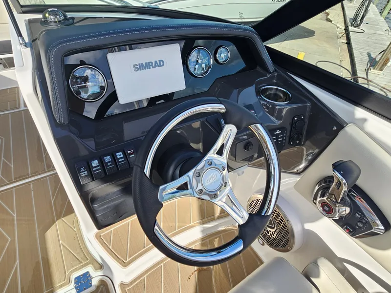 Slide: The Image of 2025 Monterey M-65 boat dashboard with steering wheel and Simrad display. - 28