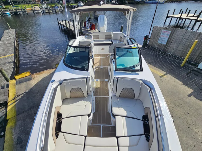 Slide: The Image of 2025 Monterey M-65 boat docked, featuring spacious seating and sleek design. - 34