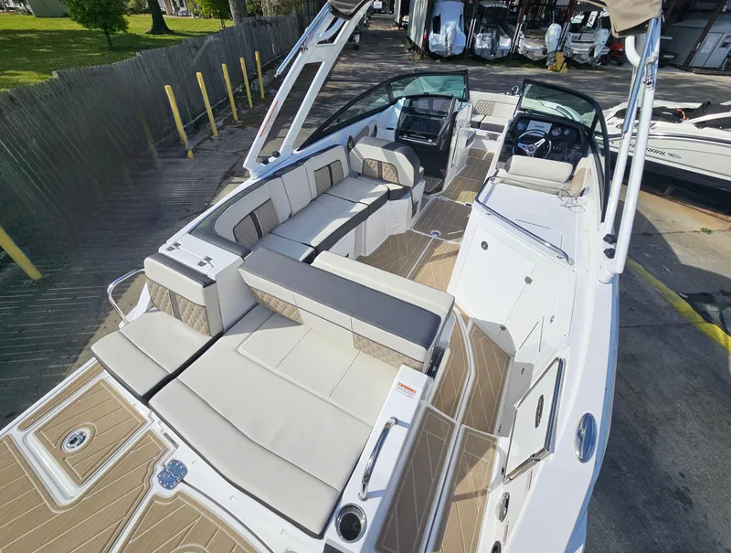Slide: The Image of 2025 Monterey M-65 boat with spacious seating and modern design in a marina setting. - 8