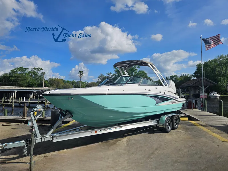 The Image of 2025 Monterey M-65 boat on trailer at North Florida Yacht Sales, under a clear blue sky. - 1