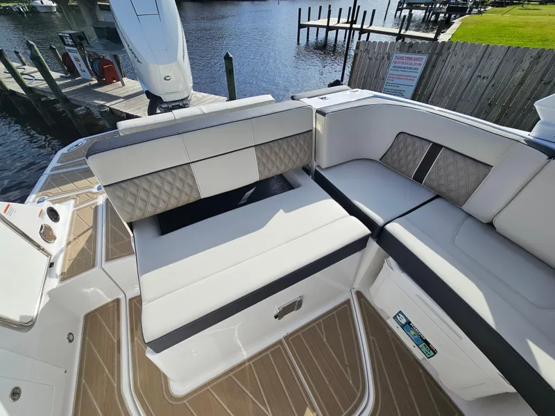 Slide: The Image of Luxury seating on 2025 Monterey M-65 boat, docked by the water. - 11