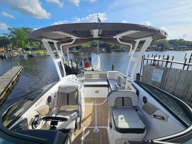 Slide: The Image of 2025 Monterey M-65 boat interior with seating, canopy, and water view. - 35