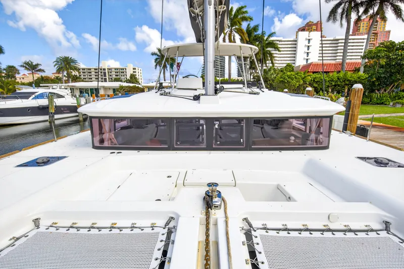Slide: The Image of 2019 Lagoon 450 F catamaran docked, showcasing spacious deck and modern design. - 24