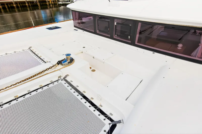 Slide: The Image of 2019 Lagoon 450 F catamaran deck with winch and netting, dockside view. - 32