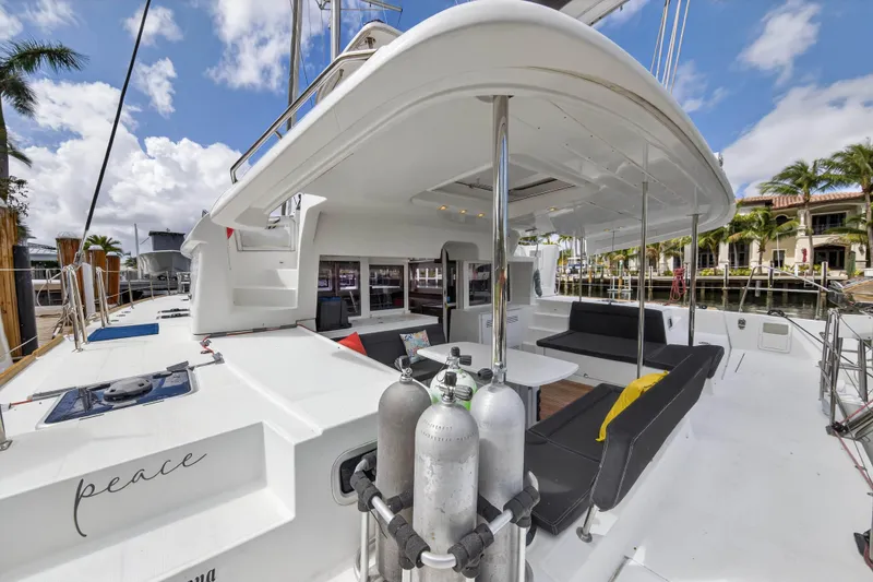 Slide: The Image of 2019 Lagoon 450 F catamaran with spacious deck, docked in a sunny marina. - 34