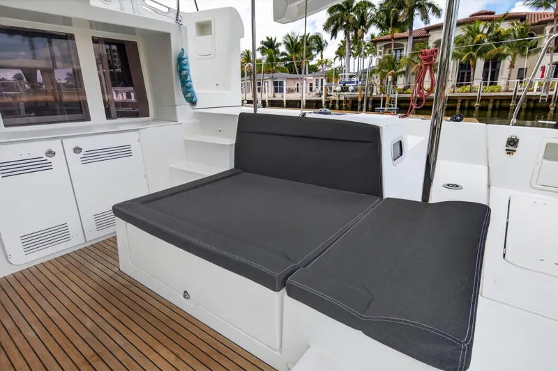 Slide: The Image of 2019 Lagoon 450 F yacht deck with cushioned seating and wooden flooring. - 42