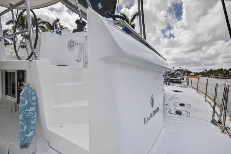 Slide: The Image of 2019 Lagoon 450 F catamaran with sleek design, docked under cloudy skies. - 45