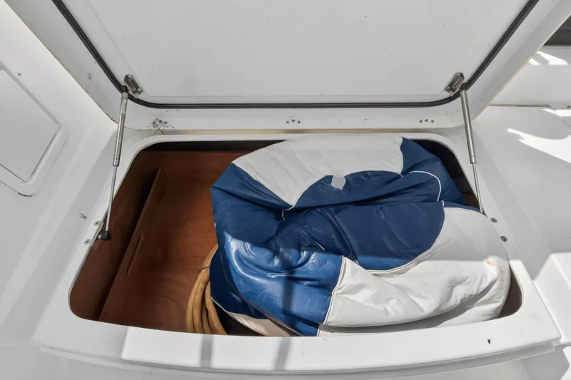 Slide: The Image of Open storage compartment on 2019 Lagoon 450 F yacht with blue and white sail. - 49