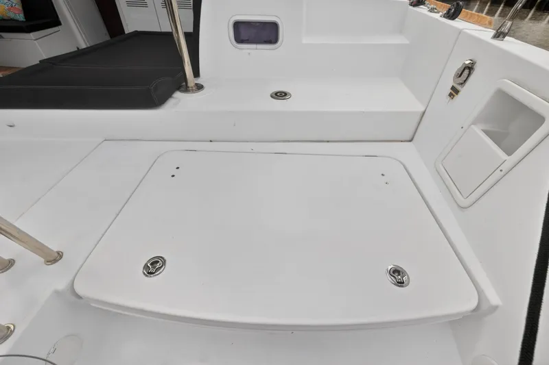 Slide: The Image of 2019 Lagoon 450 F yacht deck with storage compartment and seating area. - 50