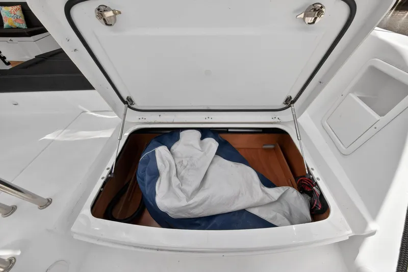Slide: The Image of Open storage compartment on 2019 Lagoon 450 F yacht, containing a folded sail. - 51