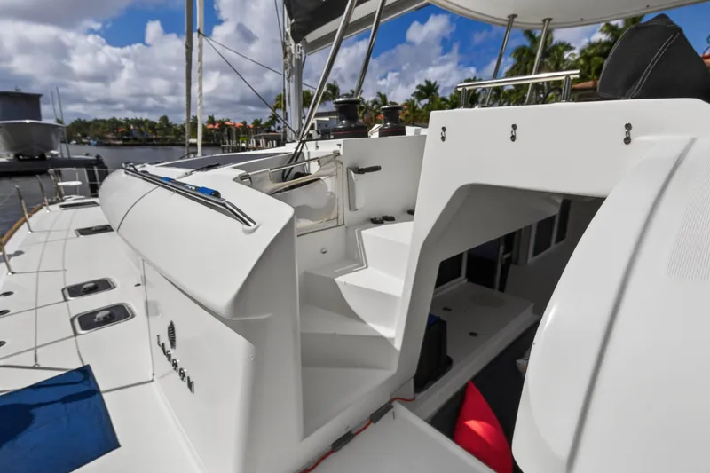 Slide: The Image of 2019 Lagoon 450 F catamaran, docked with clear skies and lush surroundings. - 53