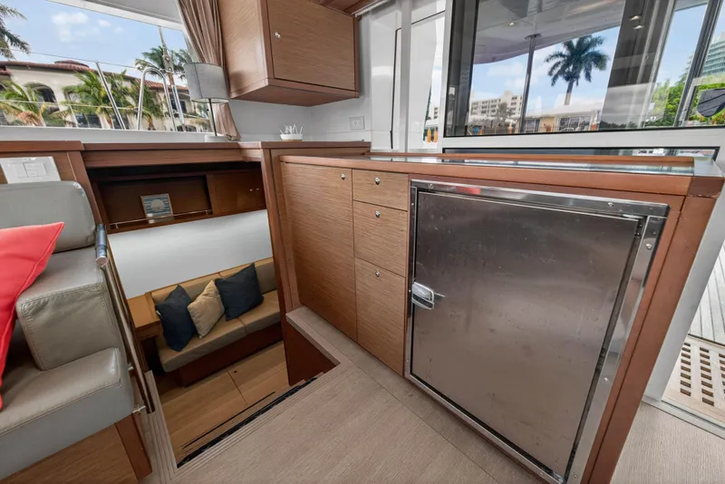 Slide: The Image of 2019 Lagoon 450 F yacht interior with modern wood cabinetry and seating area. - 64