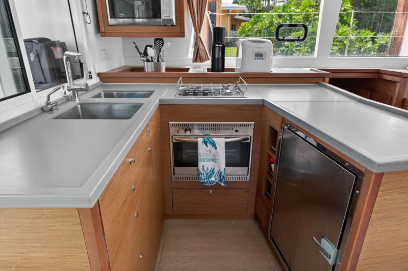 Slide: The Image of Modern kitchen in a 2019 Lagoon 450 F yacht with sleek countertops and appliances. - 67