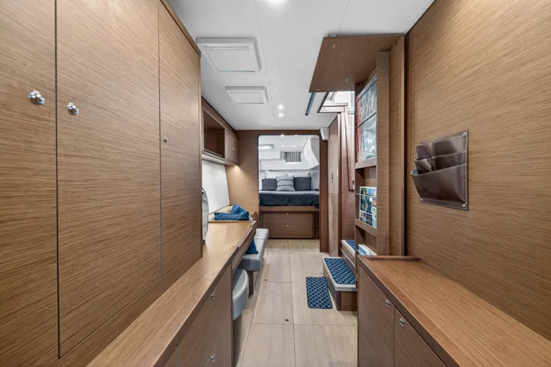 Slide: The Image of Interior of 2019 Lagoon 450 F yacht featuring modern wood finish and cozy sleeping area. - 69