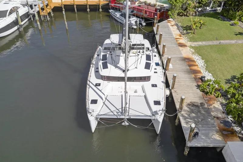 Slide: The Image of Aerial view of 2019 Lagoon 450 F catamaran docked at marina. - 7