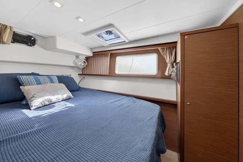 Slide: The Image of Luxurious cabin interior of 2019 Lagoon 450 F catamaran with cozy bedding and wooden accents. - 78