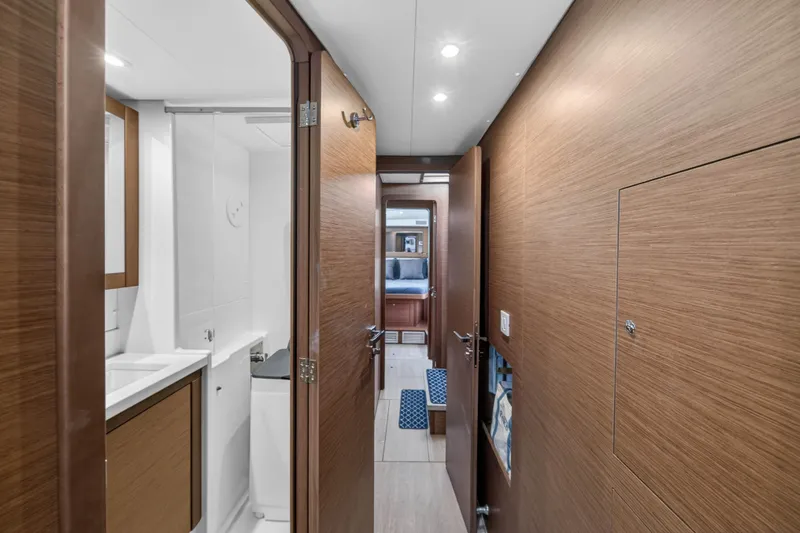 Slide: The Image of Interior hallway of 2019 Lagoon 450 F yacht, featuring wood paneling and modern bathroom. - 85