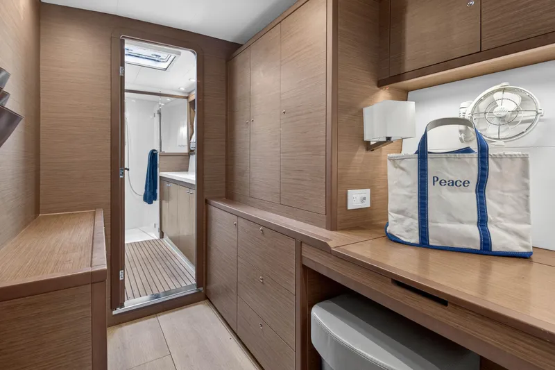 Slide: The Image of Interior of 2019 Lagoon 450 F yacht with wooden cabinetry and bathroom access. - 87