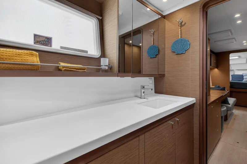 Slide: The Image of Luxurious 2019 Lagoon 450 F yacht interior with modern bathroom and wooden cabinetry. - 89