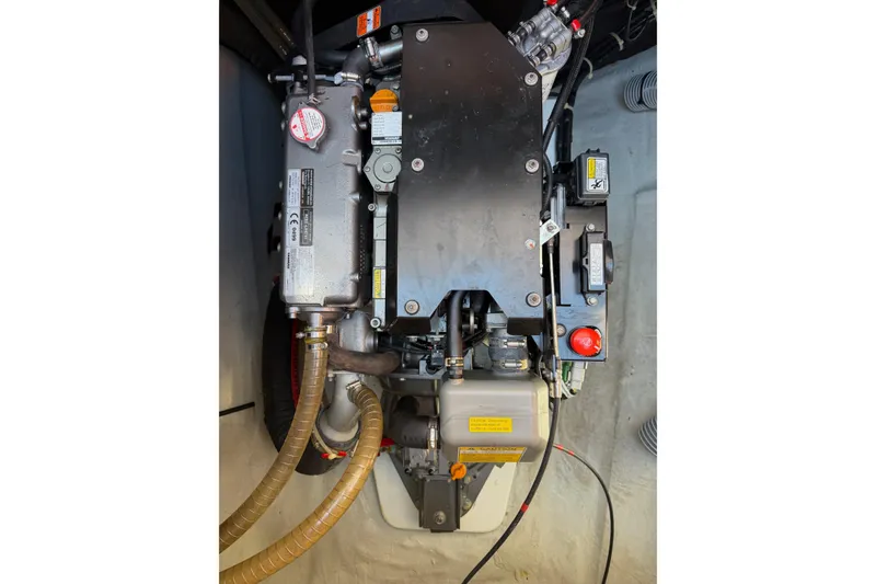 Slide: The Image of Engine compartment of a 2019 Lagoon 450 F catamaran, showcasing mechanical components and hoses. - 93