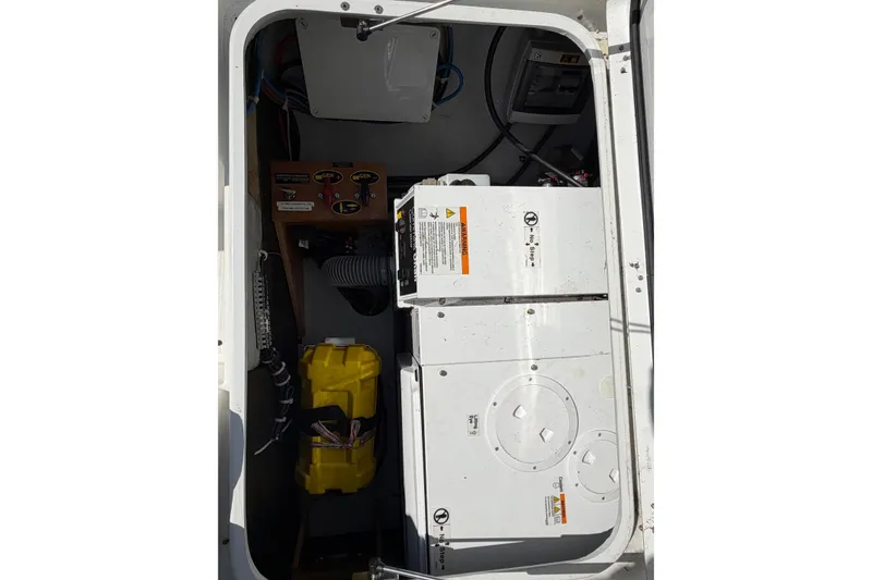 Slide: The Image of Engine compartment of 2019 Lagoon 450 F catamaran, showing mechanical components and wiring. - 97