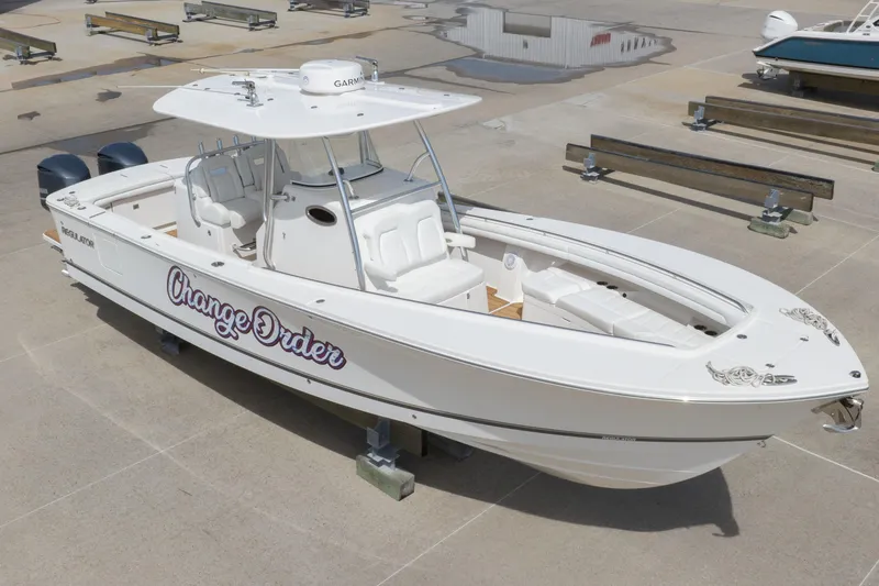 Slide: The Image of 2018 Regulator 31 boat named "Change Order" on a concrete surface. - 11